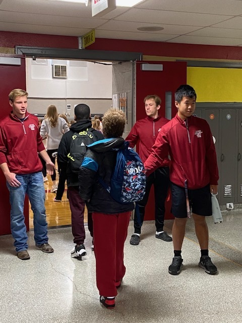 Warrensburg High School Tennis Players Greet Martin Warren students at the doors as they get off the bus.